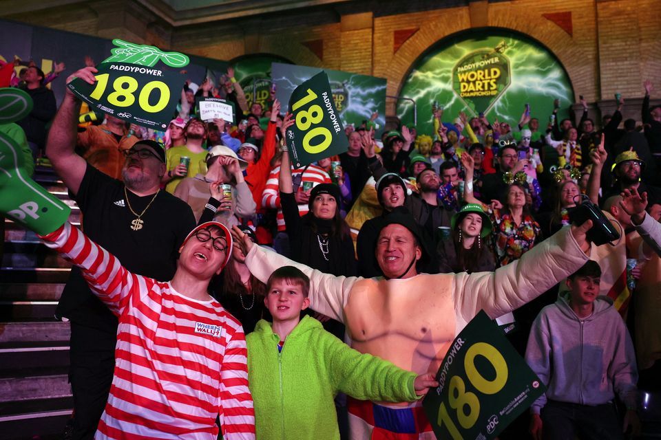 Spectators wear fancy dresses during the World Darts Championship quarter-finals at Alexandra Palace, London